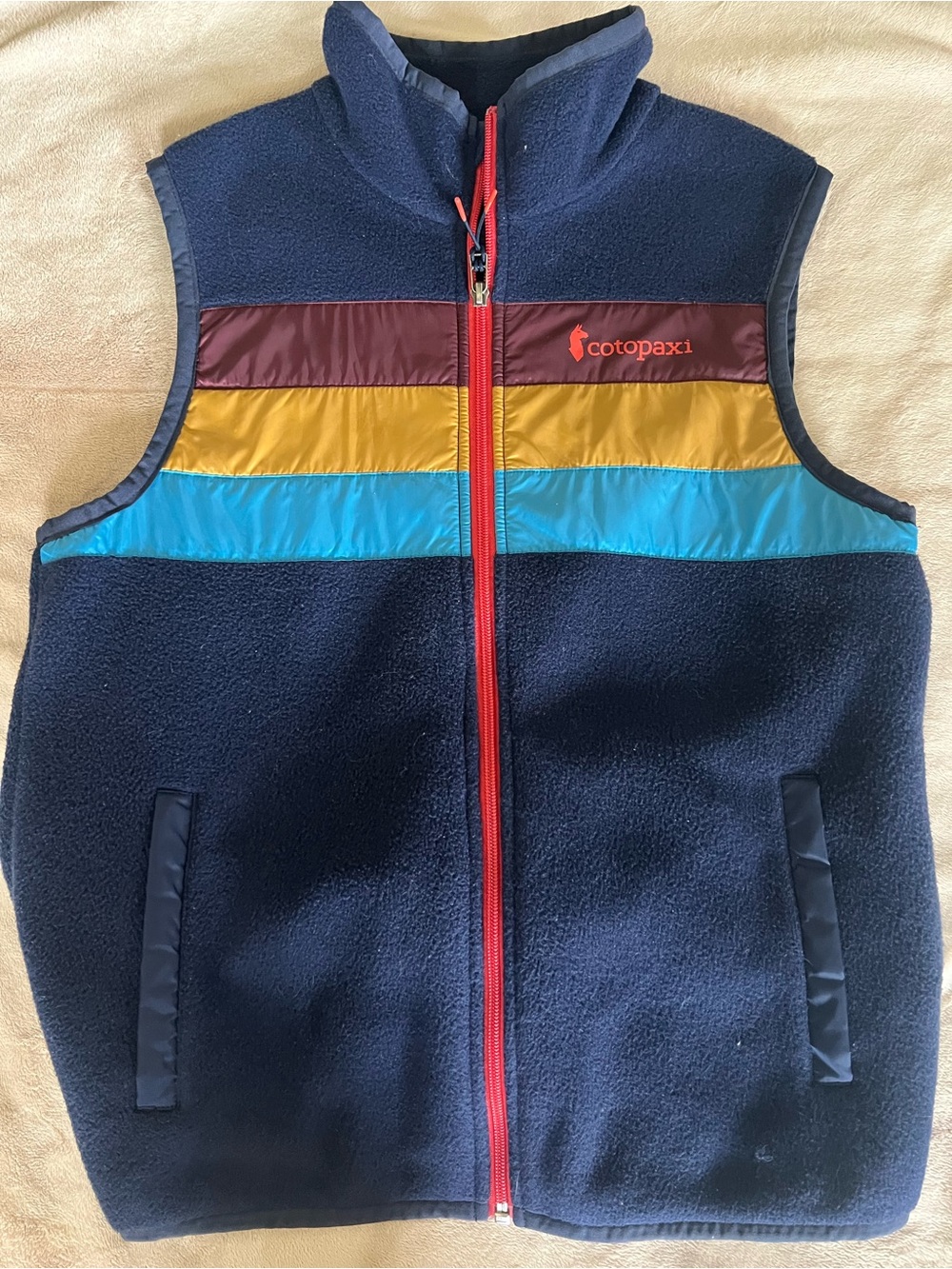 cotopaxi Navy Fleece Vest with Burgundy, Mustard, and Teal Stripes